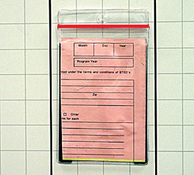 clear sealtite card holder with magnetic backing on a board